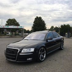 a black car parked in front of a gas station