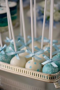 cake pops with blue and white frosting in a basket