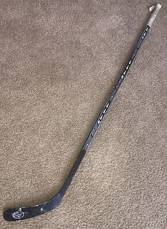 the hockey stick is laying on the carpet