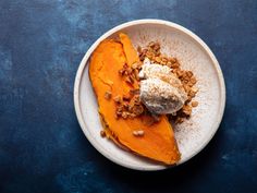 a white plate topped with food on top of a blue table