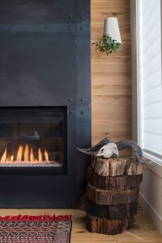 a fire place with logs in front of it