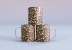 three coffee mugs stacked on top of each other in front of a blue background