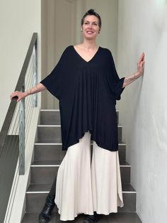 caraucci oversized black v neck empire waist tunic or mini dress #color_black Oversized V-neck Spring Cover-up, Casual Oversized V-neck Cover-up, Summer V-neck Tunic For Loungewear, Oversized V-neck Tunic For Beach Cover-up, Oversized V-neck Beachwear Cover-up, Chic Flowy Dress With Batwing Sleeves, Chic Dresses For Loungewear With Relaxed Fit, Flowy Black V-neck Beach Dress, Chic Relaxed Fit Dresses For Loungewear