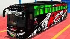 a black bus with green and red designs on it's side parked in a parking lot