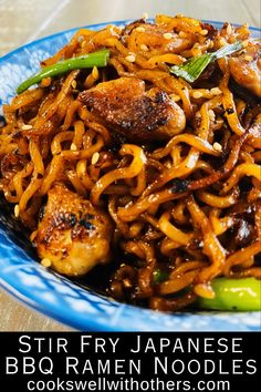 stir fry noodles with chicken and vegetables on a blue plate