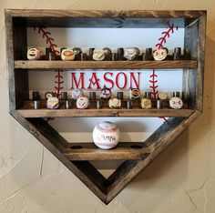 baseballs and candles are arranged in a wooden shelf with the word mason on it