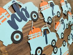 a wooden board with paper cutouts on it that say hello to the trucks and pumpkins