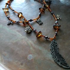 22" Handmade Steampunk Beaded Double Strand Charm Necklace. So Unique, Include Large Feather Pendant, Rose, Dragonfly, And Owl Charms. Beaded Dragonfly, Large Feathers, Feather Pendant, Hand Crafted Jewelry, Crafted Jewelry, Brown Gold, Jewelry Ideas, Handcrafted Jewelry, Jewelry Crafts