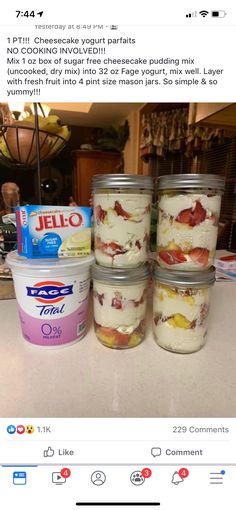 four jars of yogurt sitting on top of a counter