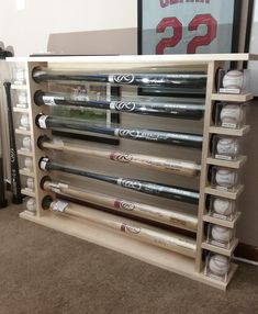 a display case with baseball bats and numbers on the wall in front of a sign