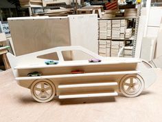 a toy car made out of plywood on a table