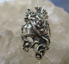 A beautiful Art Nouveau style Princess ring is hand cast in Sterling Silver. Long Flowing Hair with flowers, a Crown, and fine details are antiqued to bring out the highlights. The ring is about 1 3/16 inch long at the top and tapers down to a plain shank in the back. It is made in a size 7. I will wrap the ring in gift box and mail in a small box within 1-2 days of purchase, usually one. First Class postage with tracking is free in the U.S. . Ask about international shipping! Antique Hand Cast Rings For Anniversary, Unique Antique Silver Wedding Rings, Hand Cast Antique Rings For Anniversary, Vintage Hand Cast Engraved Round Ring, Antique Engraved Silver Ring, Vintage Silver Ring With Antique Finish, Vintage Hand Cast Rings For Anniversary, Unique Silver Rings With Antique Finish, Collectible Antique Finish Silver Rings