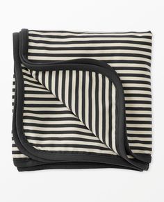 a black and white striped blanket folded on top of each other with a zippered pocket