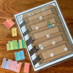 a board game that is sitting on top of a wooden table next to several pieces of paper