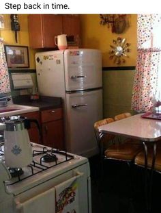 a kitchen with a table, stove and refrigerator