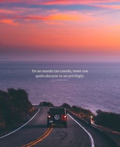 a car is driving down the road near the ocean with an inspirational quote above it