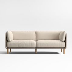 a white couch sitting on top of a wooden frame