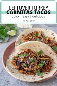 two pulled pork tacos on a pink plate with cilantro and green garnish