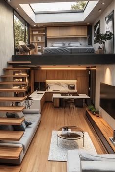 a living room with stairs leading up to the top floor and a loft bed above it