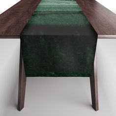 a wooden table with a green cloth on it