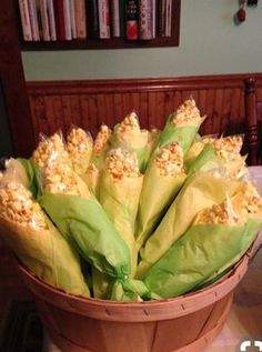 a basket filled with corn sitting on top of a table