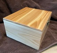 a wooden box sitting on top of a bed