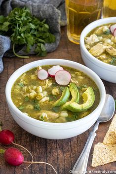 two white bowls filled with soup and vegetables