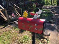 a red mailbox with a cartoon character on it