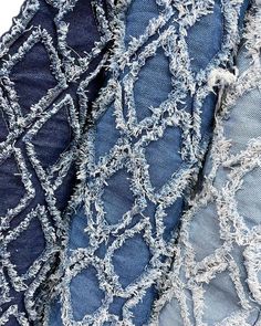 two pieces of denim fabric with frayed edges