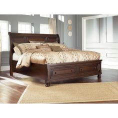 a large bed sitting on top of a wooden floor