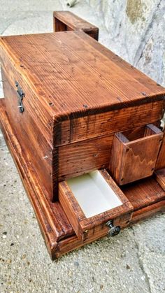 an old wooden box with drawers on the ground