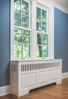 an empty room with blue walls and white trim on the window sill is shown