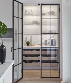 an open glass door leading into a kitchen