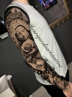 a man with a tattoo on his arm that has an image of the virgin mary