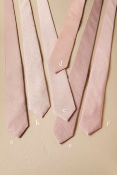 four different types of ties laid out on top of each other, all in pink and white