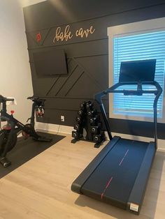 a home gym with treadmills and exercise bikes in the room, along with other equipment