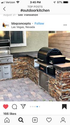 an outdoor kitchen with bbq grills and oven on the side of the house