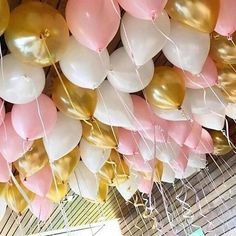 a bunch of balloons that are hanging from the ceiling