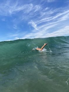 a person swimming in the ocean on a surfboard