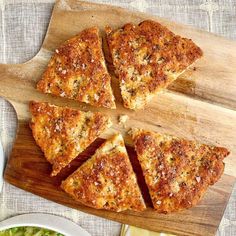 slices of pizza sitting on top of a wooden cutting board