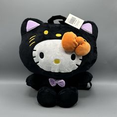 Hello Kitty Halloween Cat Plush Backpack Go Trick-Or-Treating With The Purr-Fect Plush Backpack! It's Designed Like Hello Kitty Wearing A Black Cat Costume And Is Complete With A Back Zipper Pocket And Adjustable Straps. * 14" * Polyester * Back Zipper Pocket * Imported * Seller Not Responsible For Manufacture Defects Hello Kitty Plushie Backpack, Goth Hello Kitty Backpack, Playful Hello Kitty Backpack, Hello Kitty Plush Bag, Black Cat Design Standard Backpack, Black Cat Costumes, Plush Backpack, Hello Kitty Halloween, Cat Plush