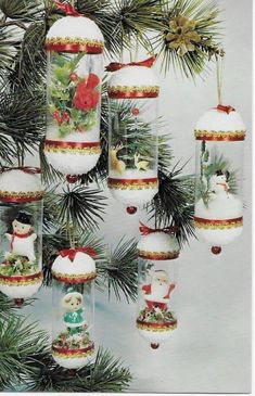 an ornament hanging from a christmas tree decorated with snowmen and other ornaments