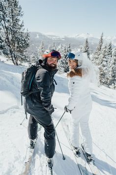 two people on skis posing for the camera