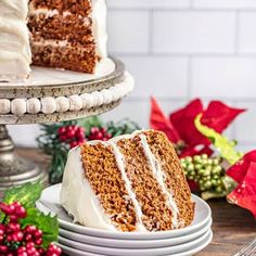 a slice of carrot cake with white frosting on a plate next to the rest of the cake