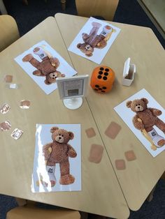 there is a teddy bear on the table with pictures and magnets to put on it