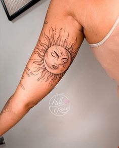 a man with a sun tattoo on his arm