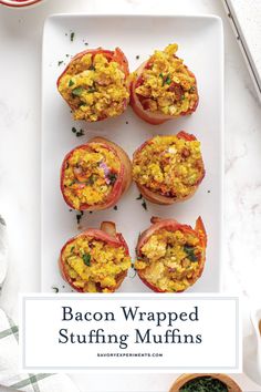 bacon wrapped stuffed muffins on a white plate next to bowls of spinach