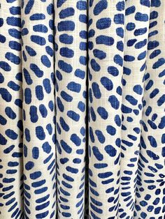 blue and white animal print curtains hanging on a wall