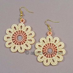 two pairs of earrings with pink and white threadwork on the bottom, one has a flower