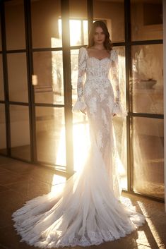 a woman in a wedding dress is posing for the camera